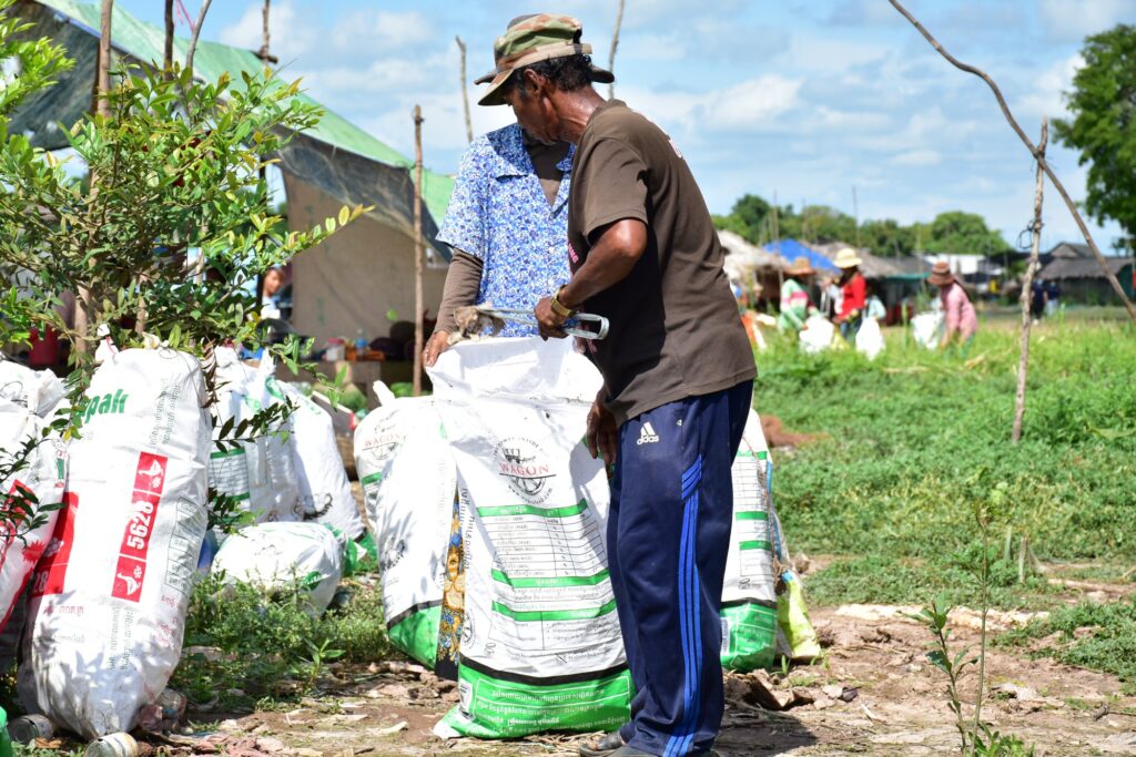 A man sorts filled plastic collection bags